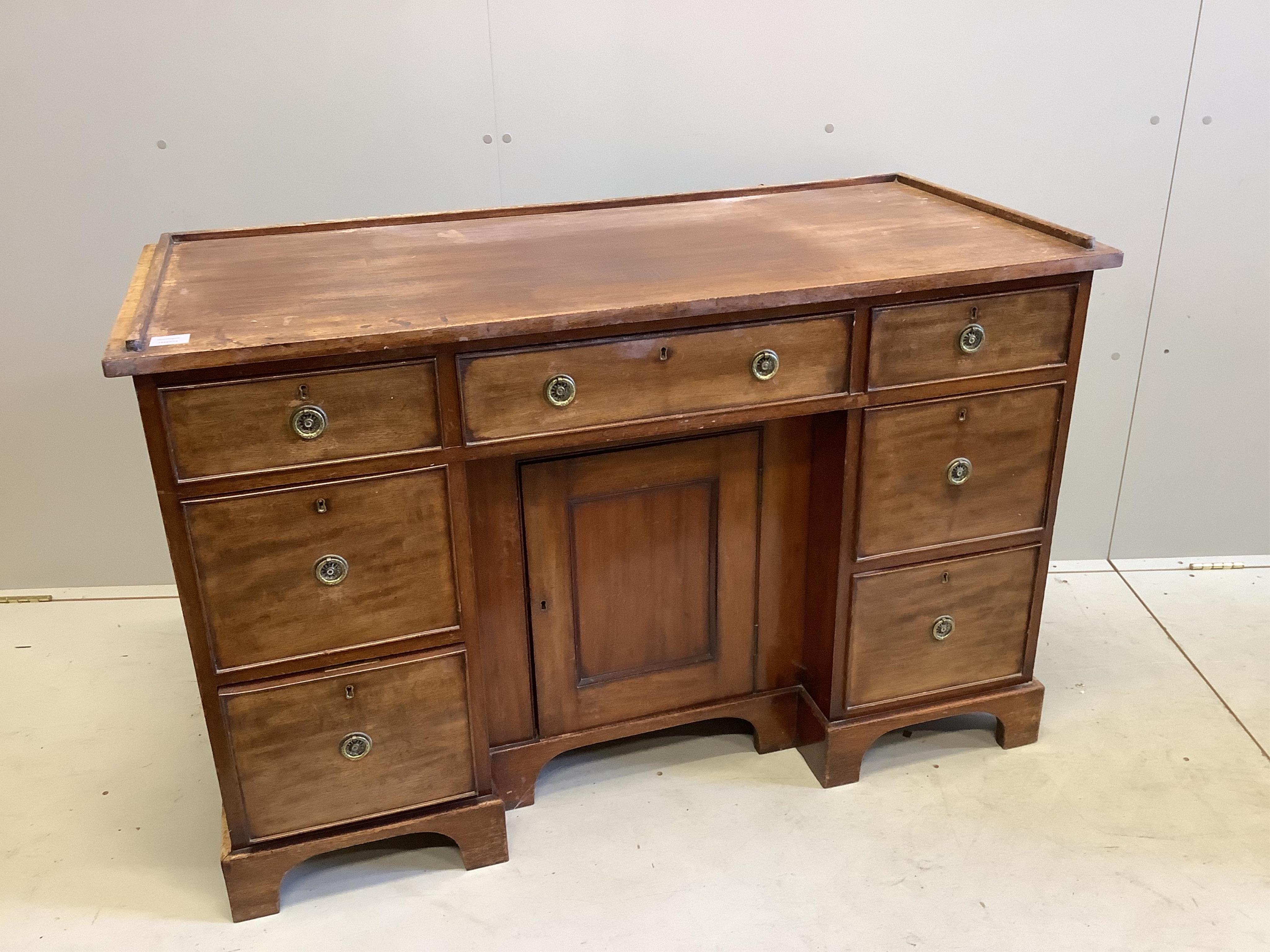 A Regency mahogany galleried topped dressing chest, fitted seven drawers, about a kneehole cupboard, width 127cm, depth 55cm, height 83cm. Condition - fair